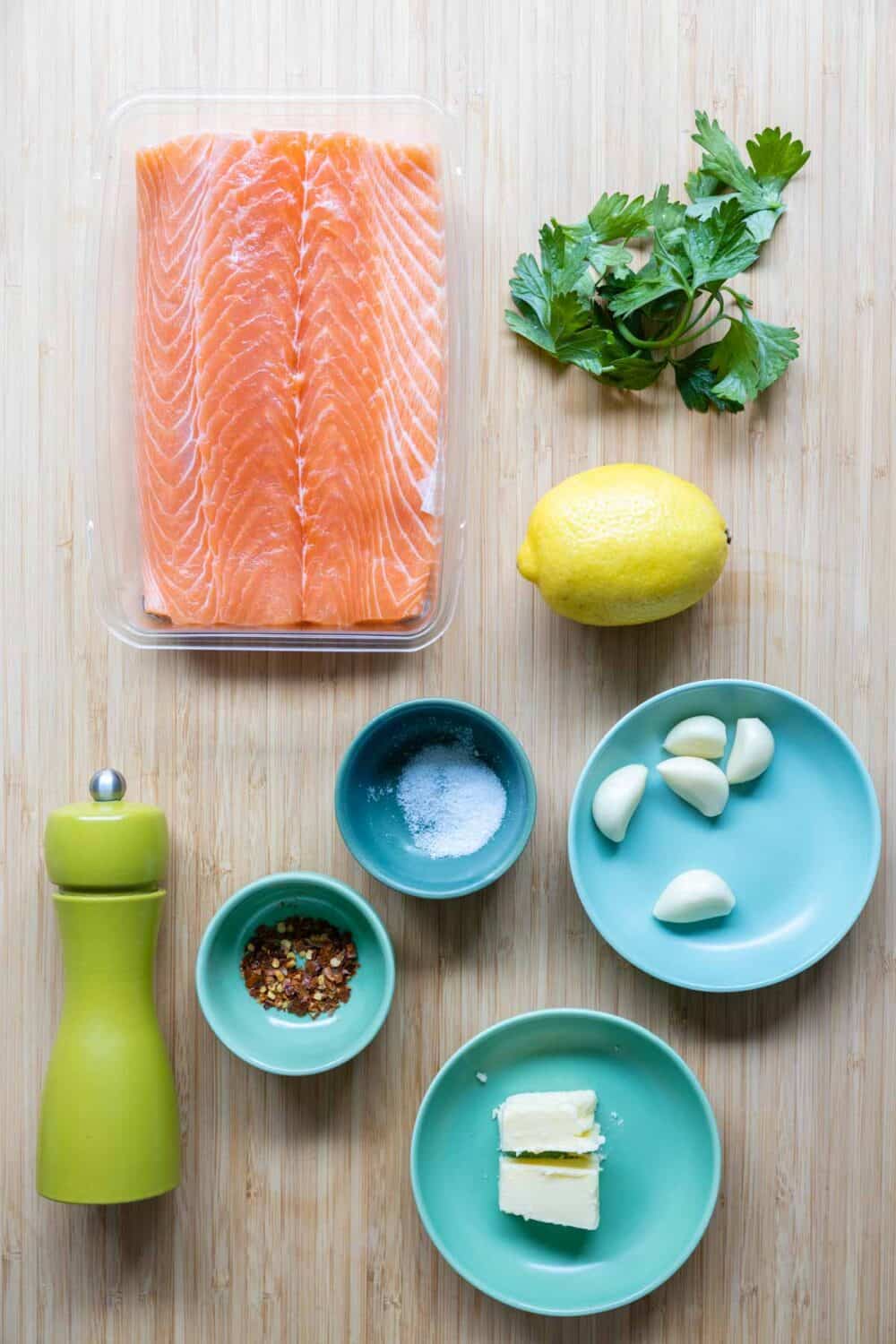Ingredients to make pan-seared salmon laid out on a kitchen counter.