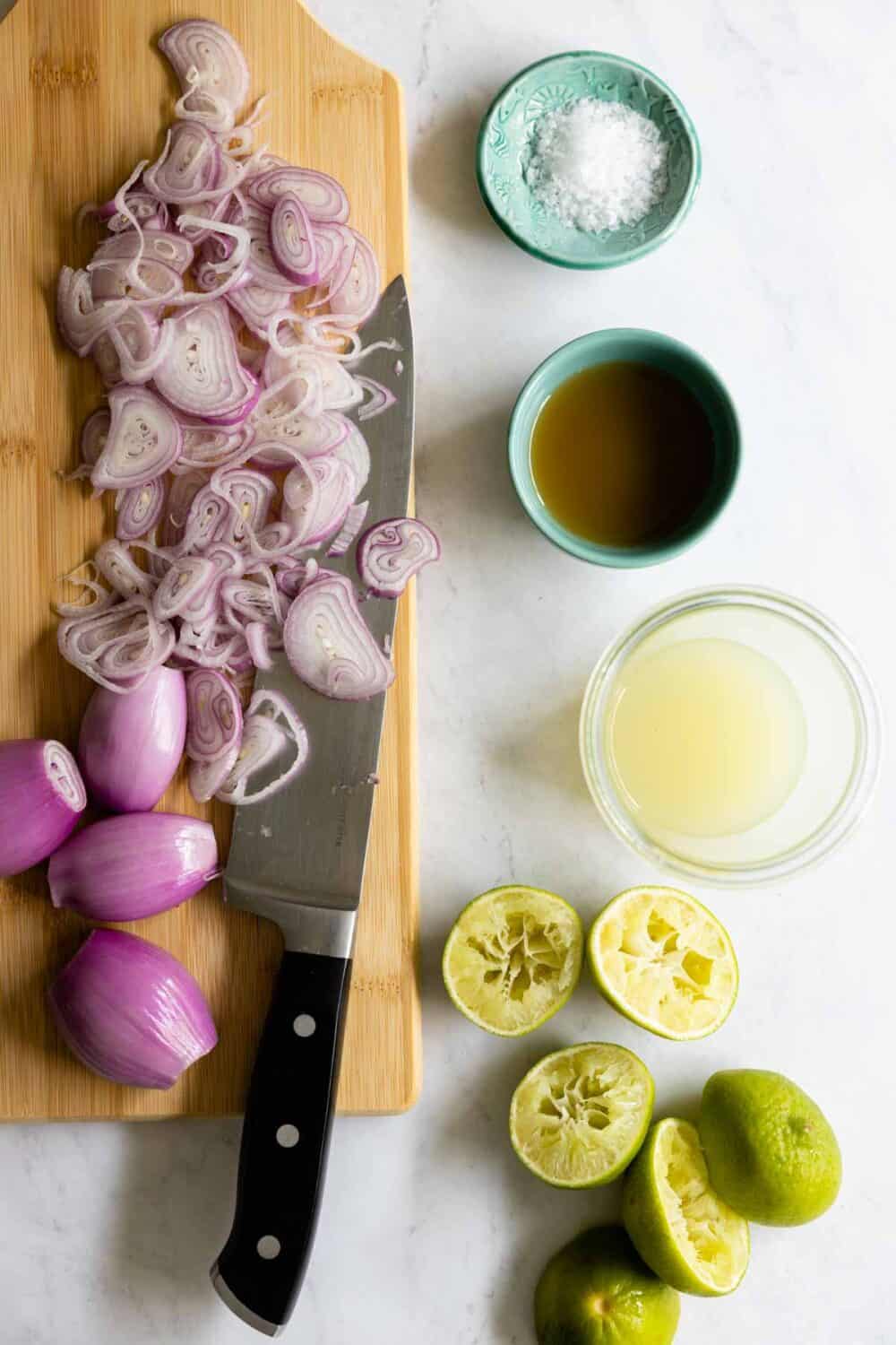 Ingredients for pickled shallots laid out on a kitchen counter.