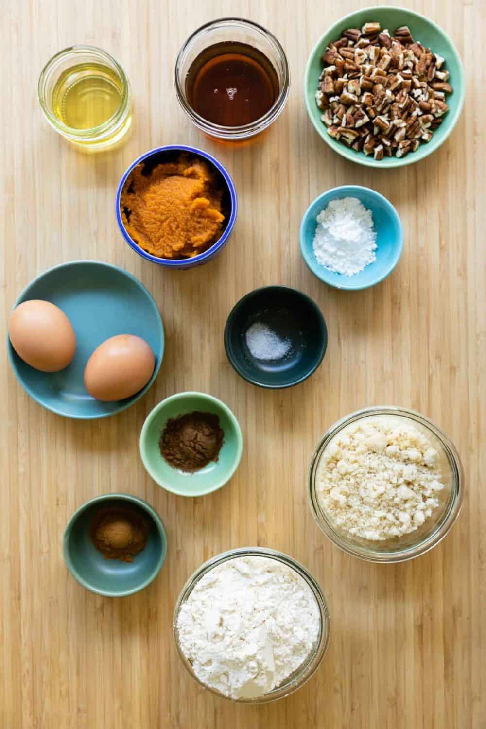 Ingredients for a healthy pumpkin bread laid out on a kitchen counter.