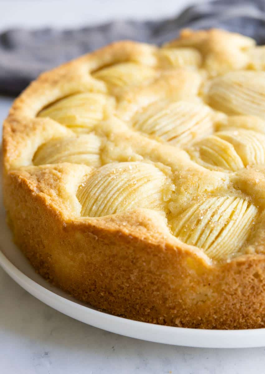 German Apple Cake, also known as Versunkener Apfelkuchen, on a white plate.