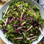 Simple kale salad in a light grey bowl.