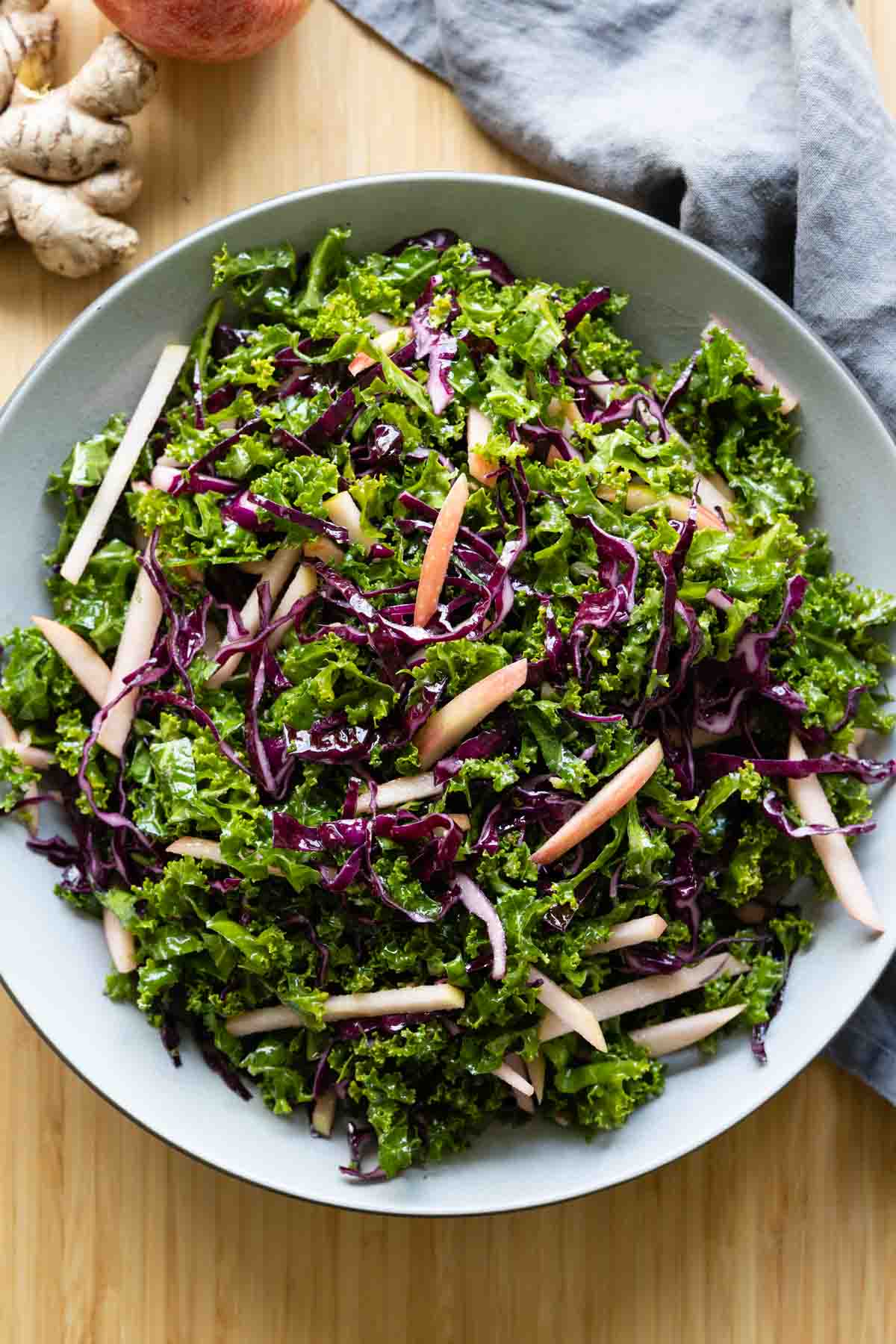 Simple kale salad in a light grey bowl.