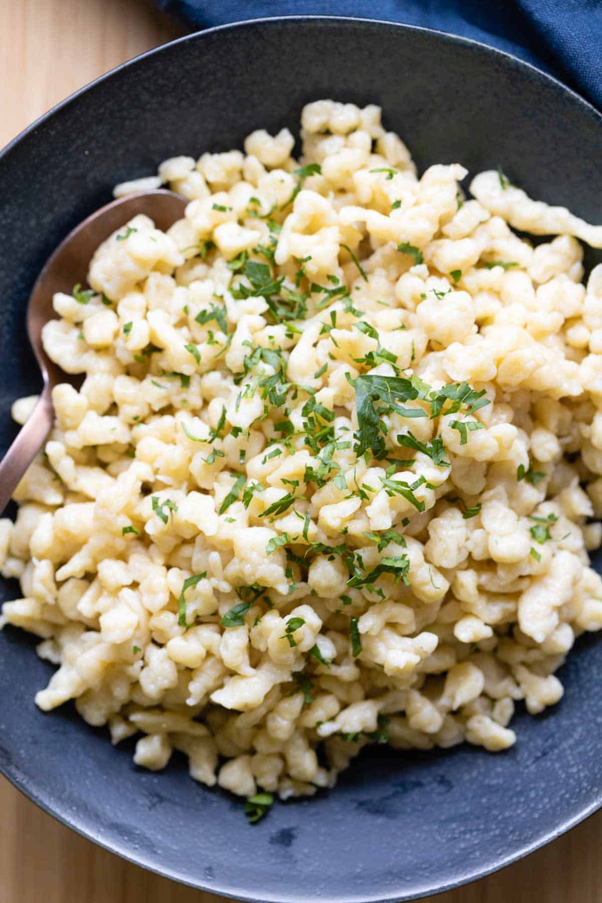 German Spaetzle served in a blue bowl.