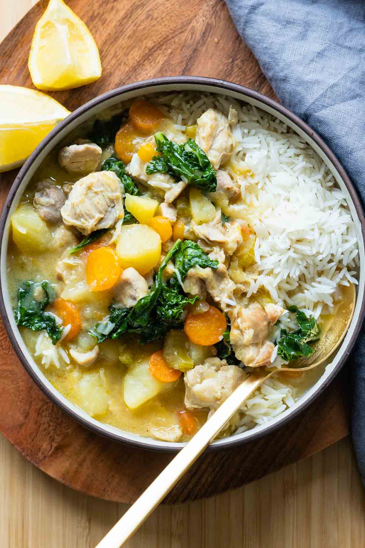 Instant Pot Chicken Stew served over rice in a bowl.
