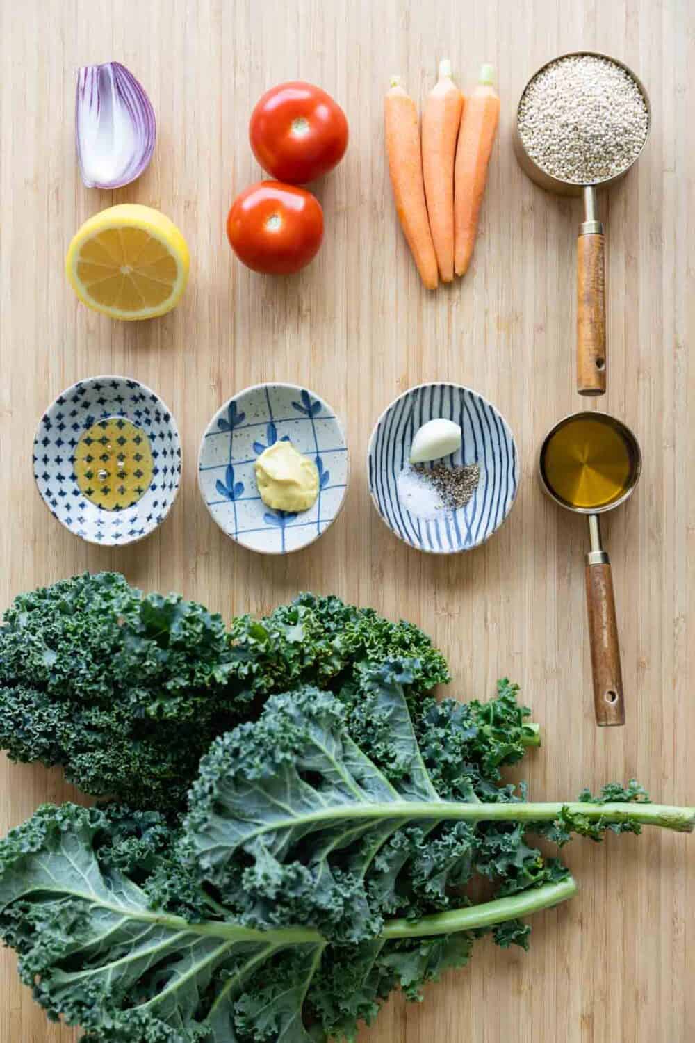 Ingredients for kale quinoa salad laid out on a kitchen counter.