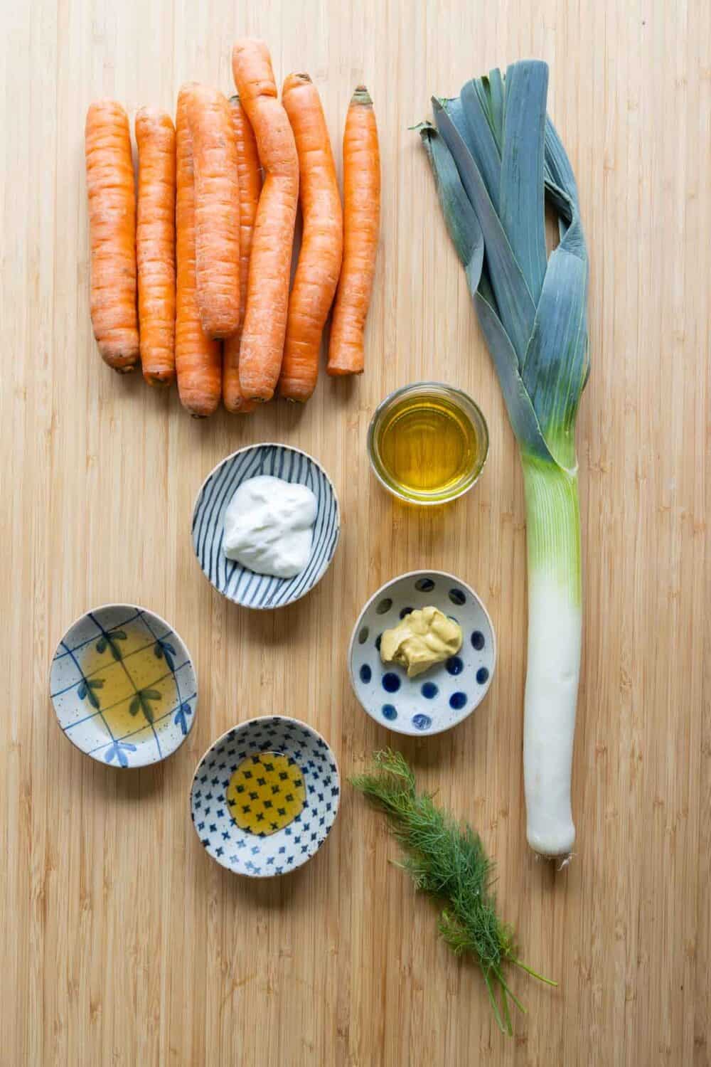 All ingredients for the grated carrot salad laid out on a kitchen counter.