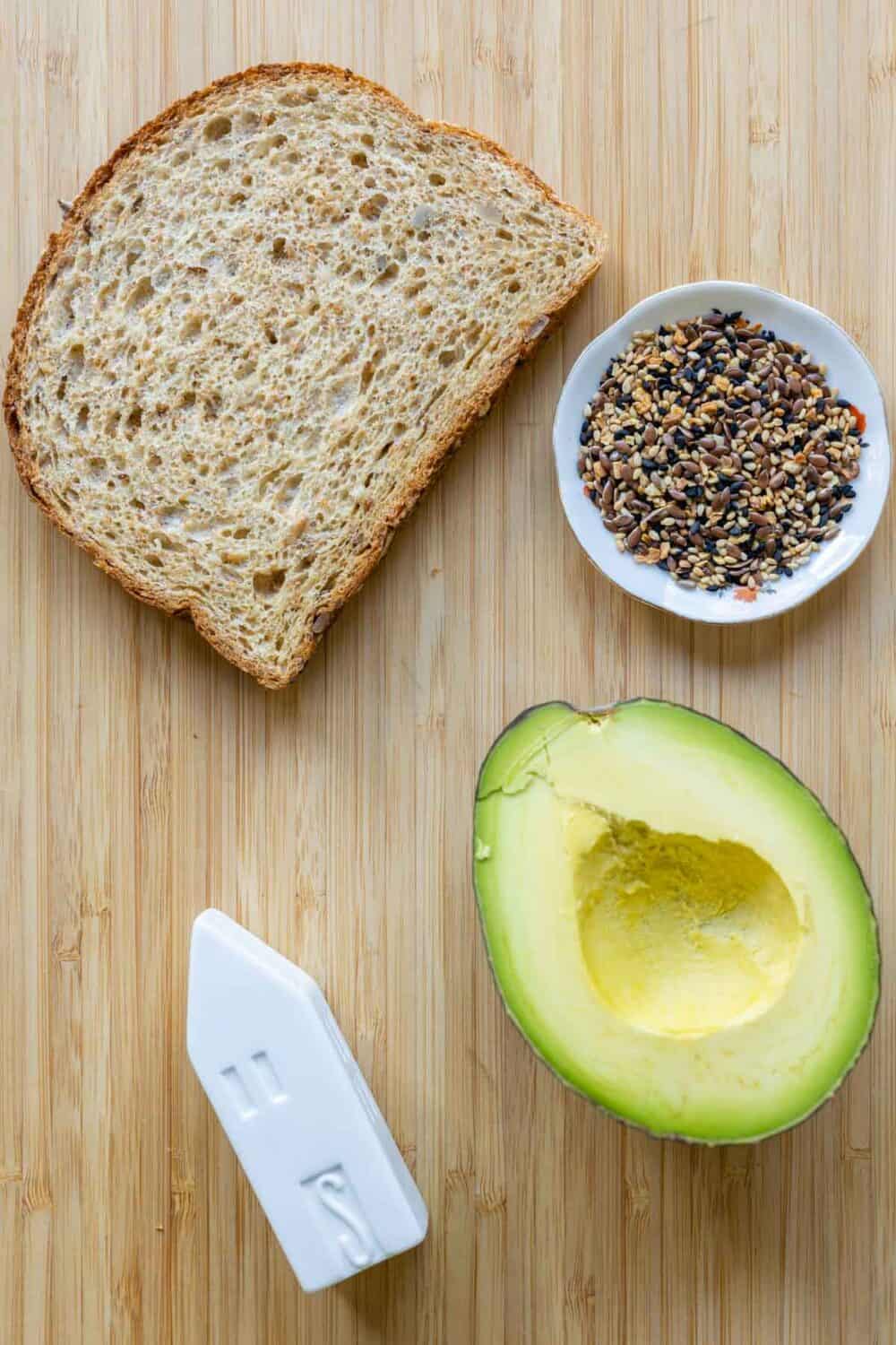 Ingredients for avocado toast laid out on a kitchen counter.