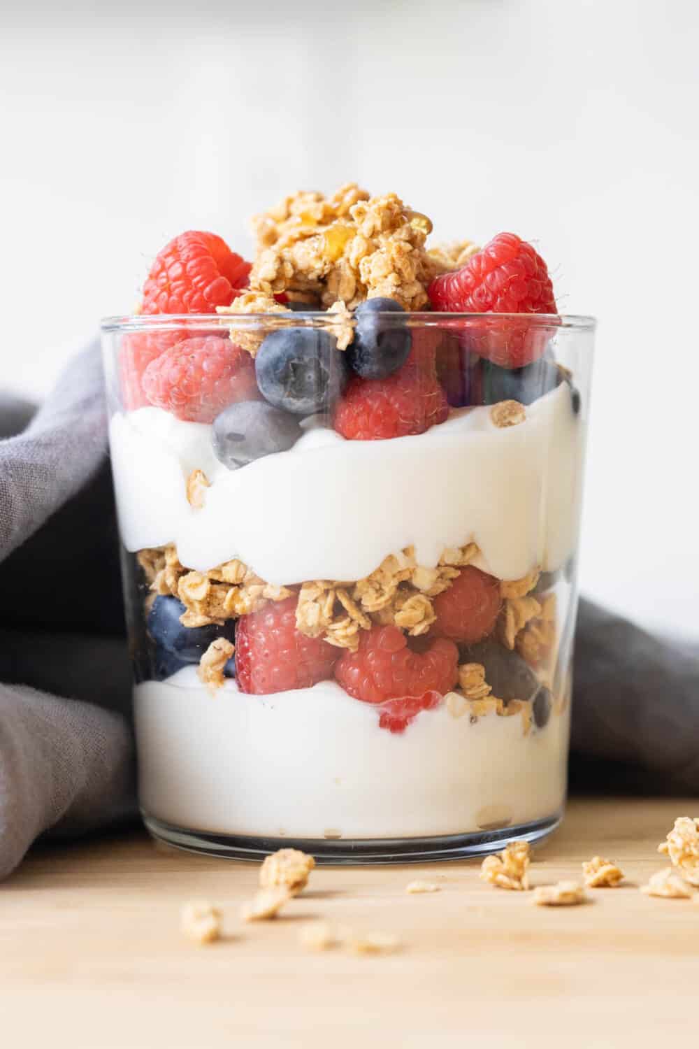 Greek Yogurt Parfait in a clear drinking glass.