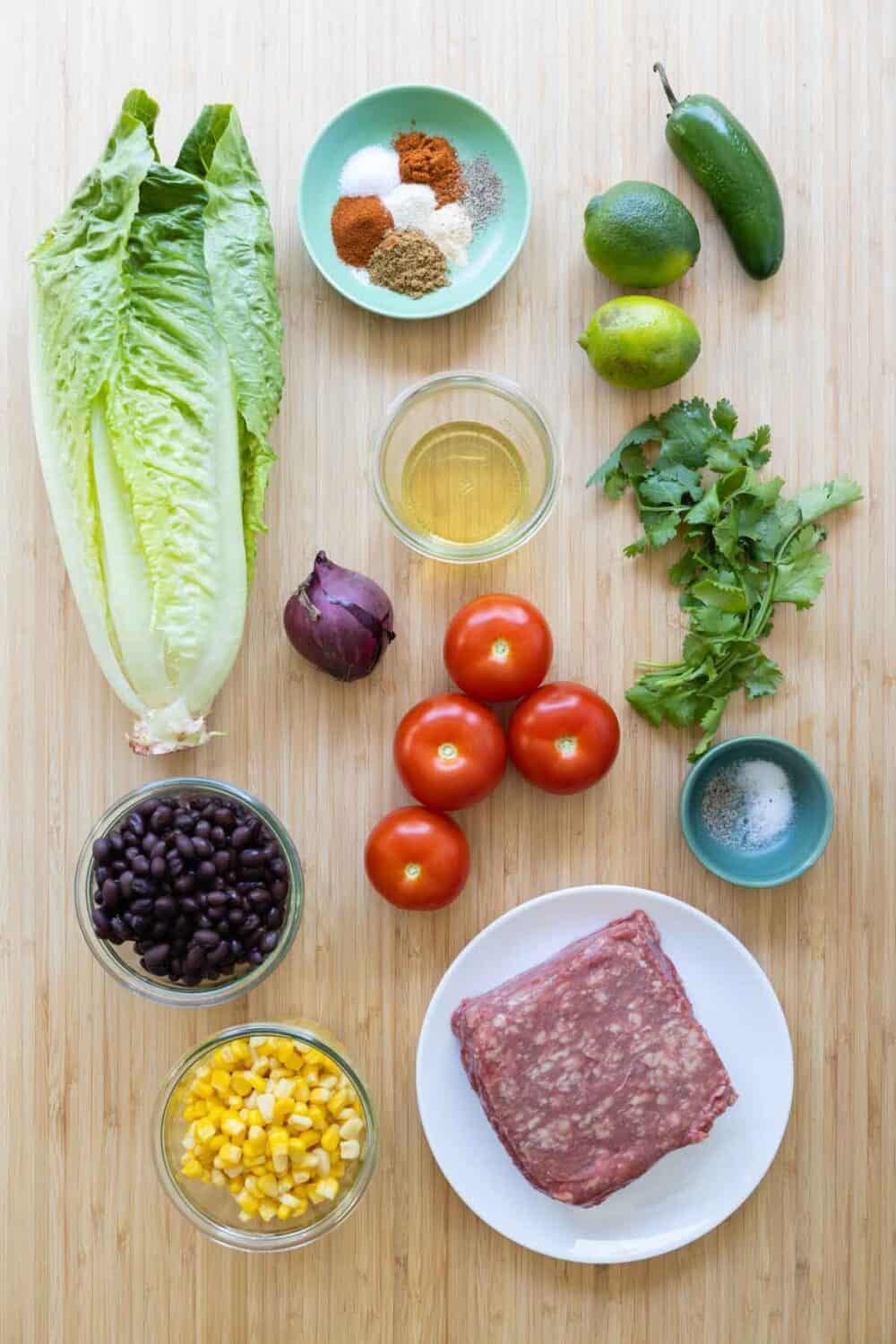Ingredients for meal prep burrito bowls laid out on a kitchen counter. 