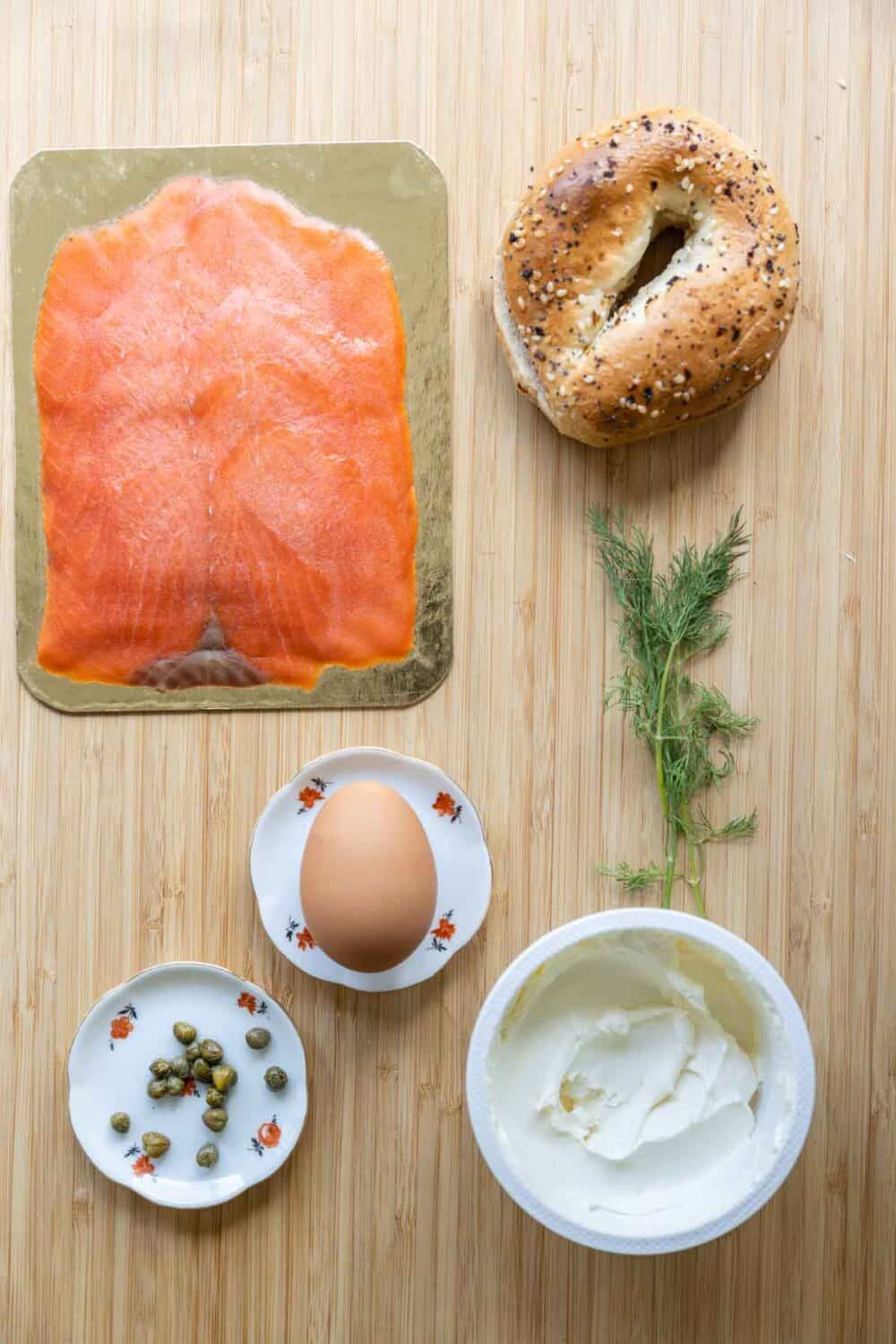 Ingredients for salmon bagel laid out on a kitchen counter.