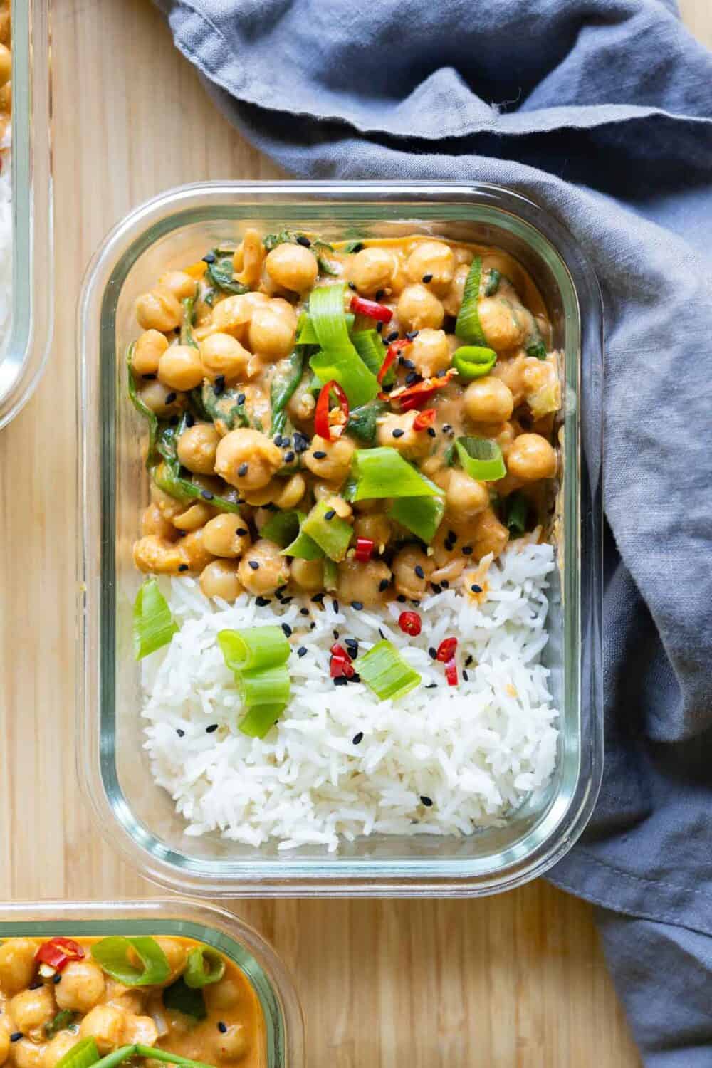 Chickpea curry and rice in a rectangular glass container.
