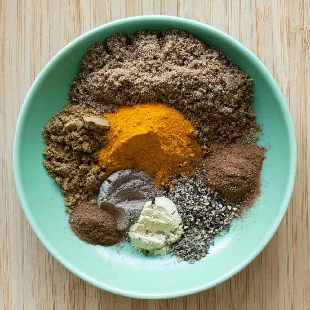 All spices needed to make Mauritian Curry Powder shown separately in a small green bowl.